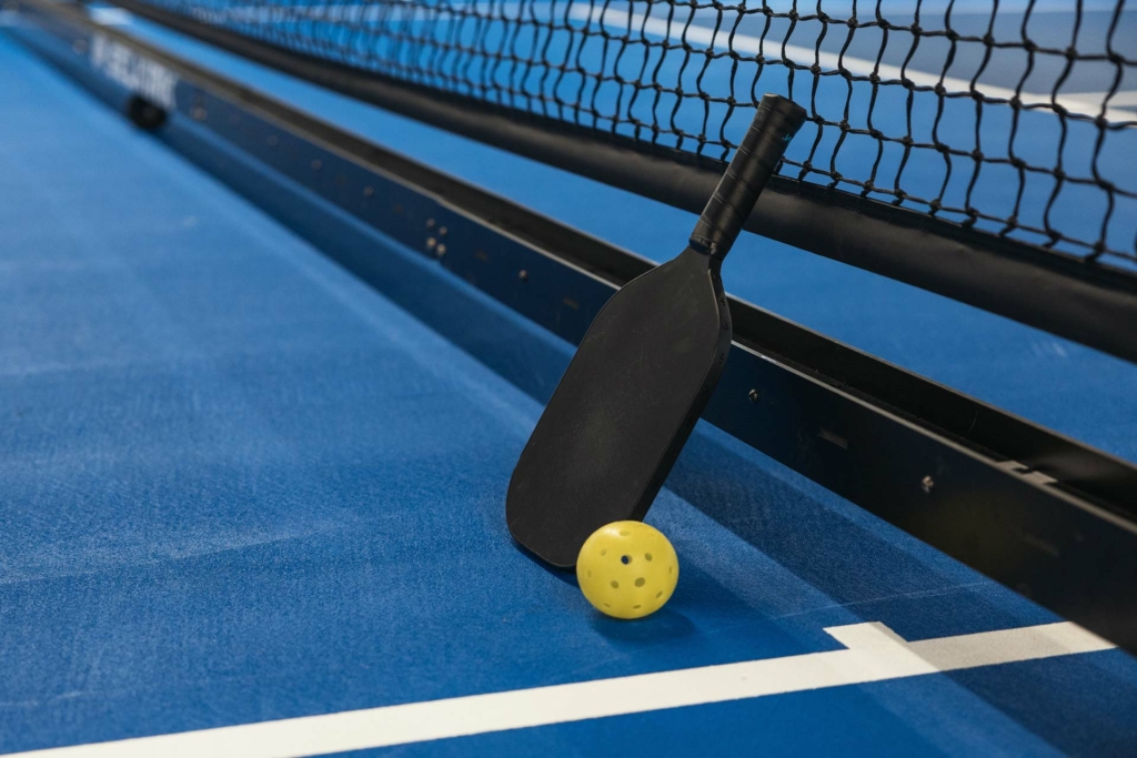 Pickleball combines elements of tennis, badminton, and ping-pong using a paddle and plastic ball.